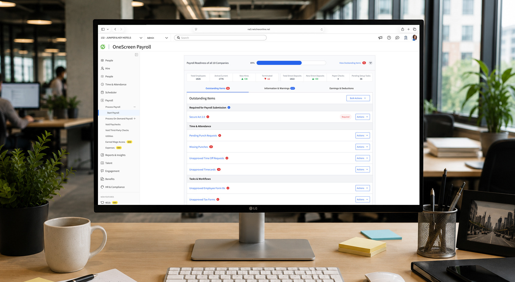 OneScreen Payroll readiness dashboard for Netchex listing outstanding items across ten companies, on an office monitor